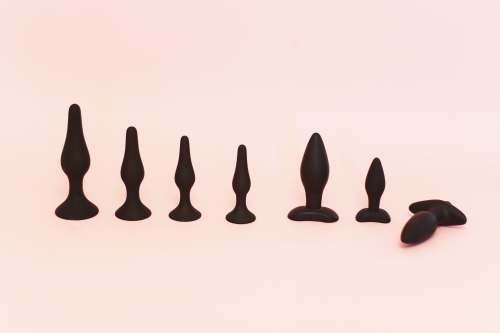 sexy ass black human figure on white surface dildo